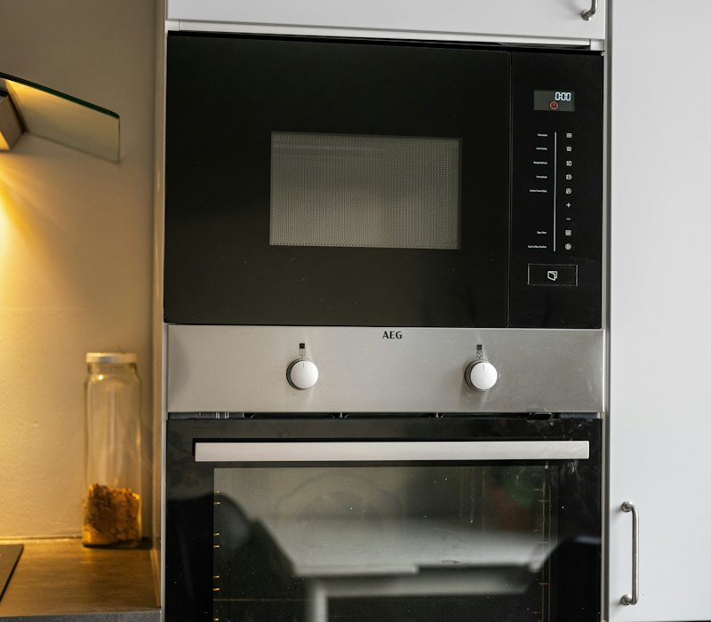 Built-in oven and microwave set into kitchen cabinets