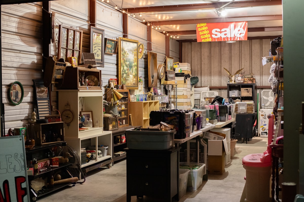 Second-hand furniture shop floor stacked with sofas, tables and chairs