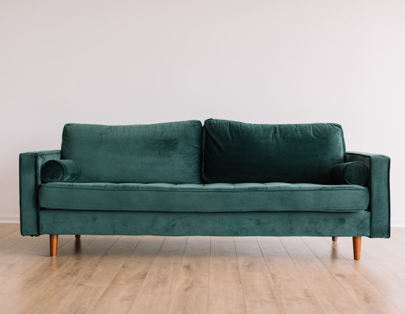 Green velvet three-seater sofa