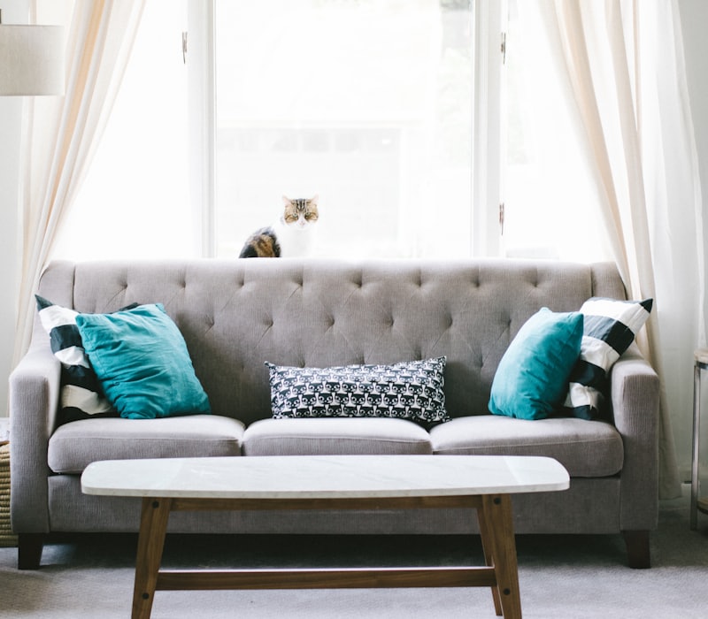 Grey tufted three-seater sofa