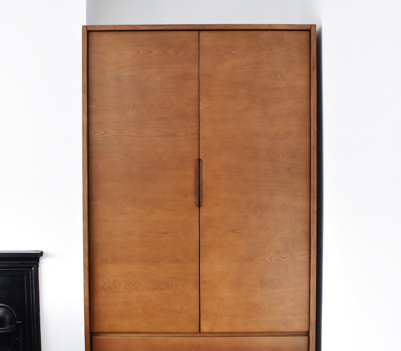 Tall wooden wardrobe with panelled doors
